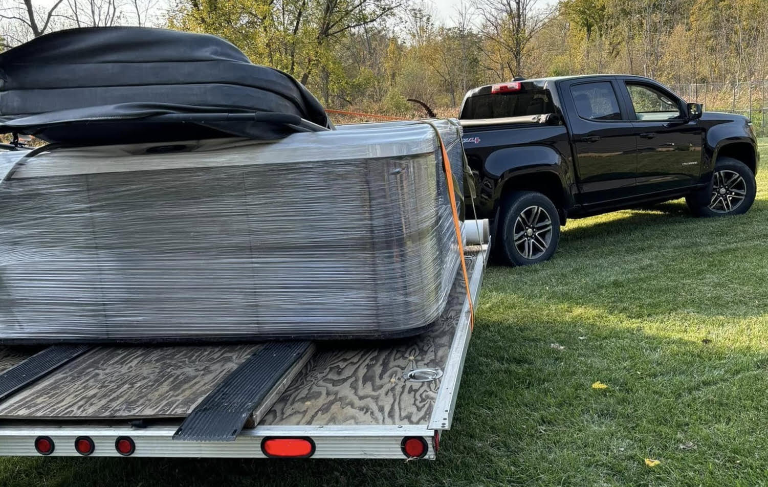 Hot tub wrapped and secured on a trailer, ready for transport across Western New York
