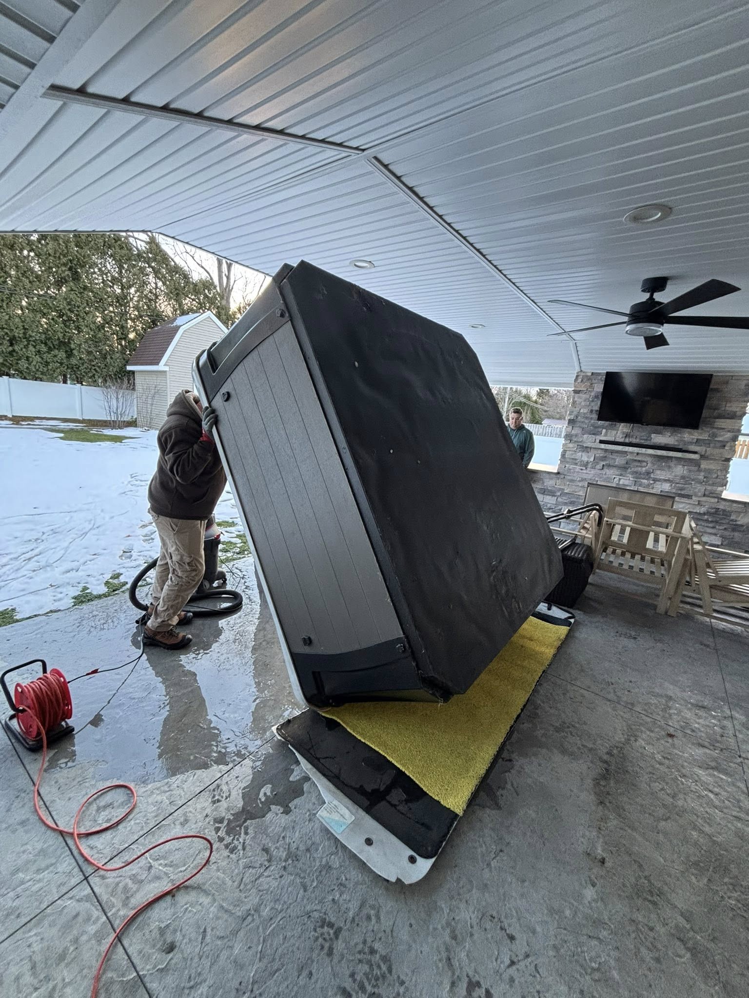 Team moving a hot tub in Western New York